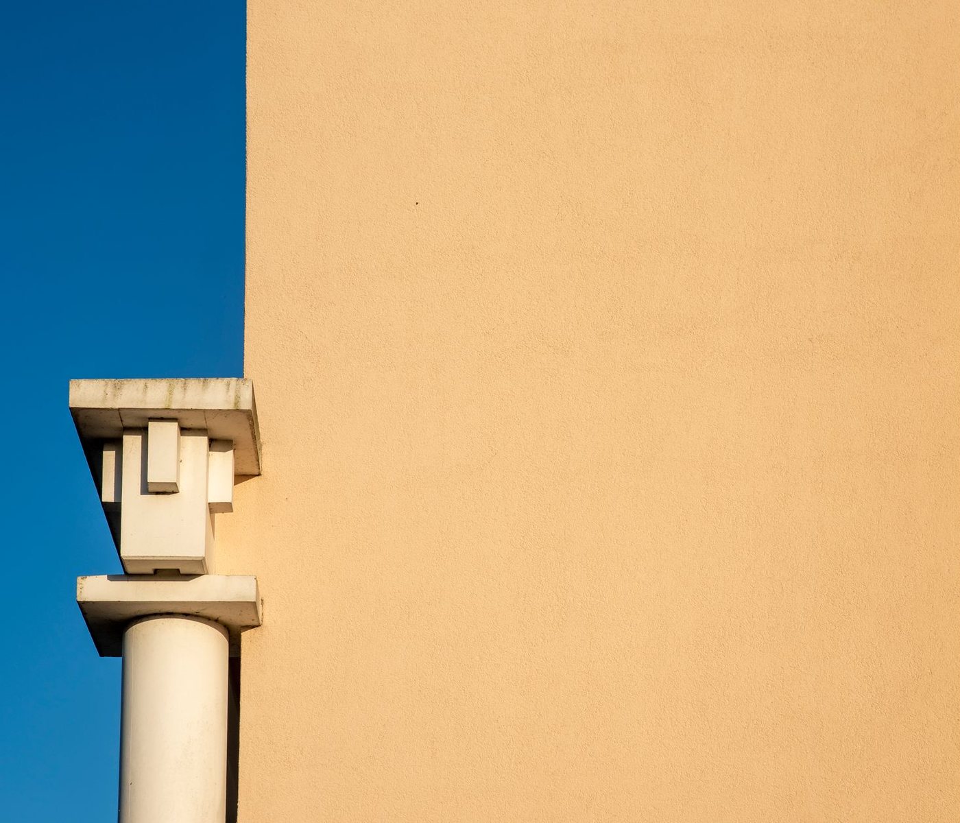 Stepped Art Deco detail against the cream render of the building